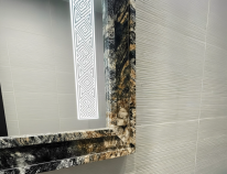 Snippet of a custom-frosted mirror with aesthetic tiles seamlessly blends into a classy bathroom.