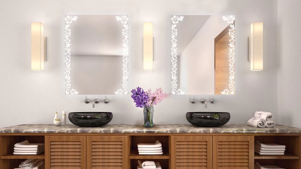 Two rectangular flower patterned mirrors with lights and cuboid alabaster above a sink pair in Oman.