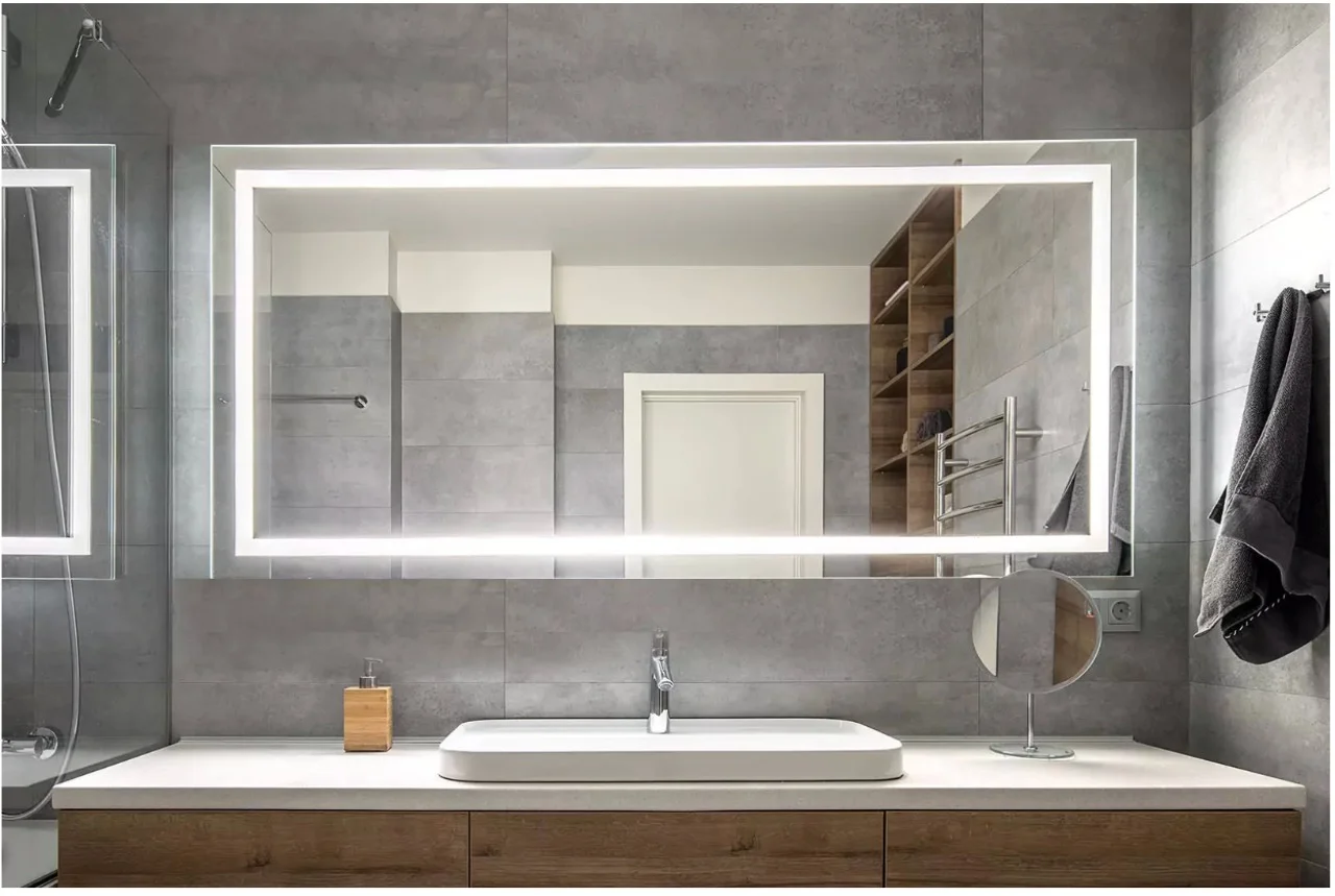 Illuminated mirror in dubai incorporated into an ivory matt tiled wall above a single valve.
