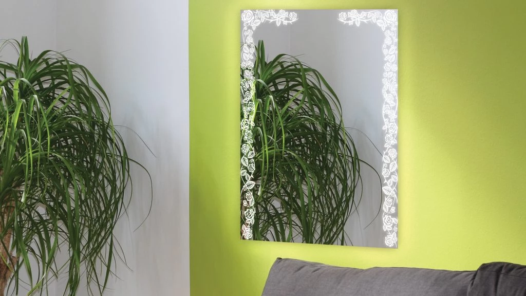 Light up mirror with french inspired light frame design mounted on a yellow-green wall in Oman.